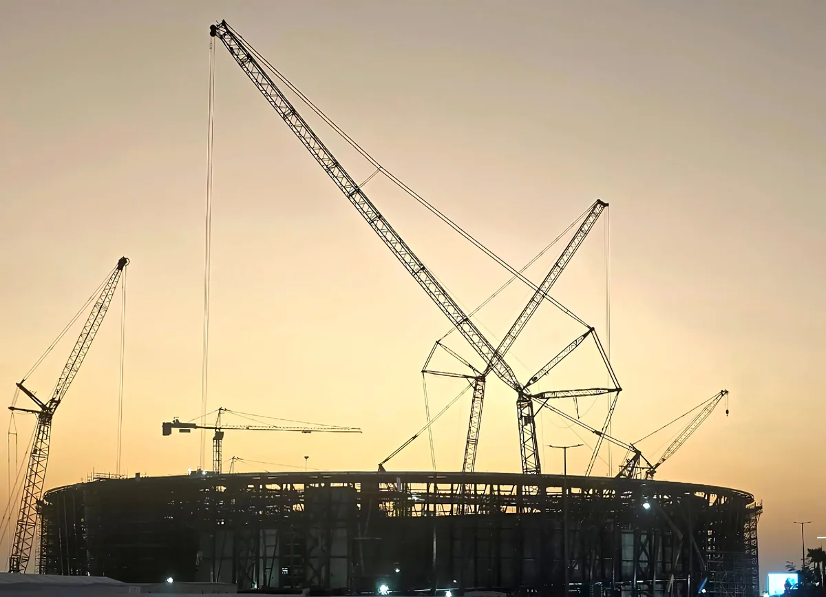 The velodrome structure under construction at sunset